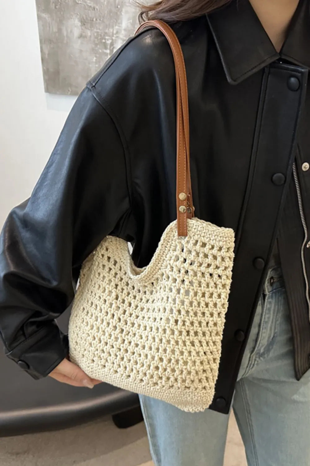 Ivory crochet weave shoulder bag with tan leather strap detail.