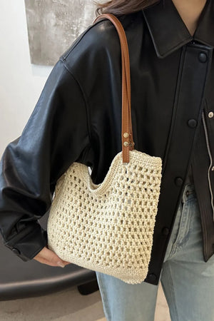 Ivory crochet weave shoulder bag with tan leather strap detail.