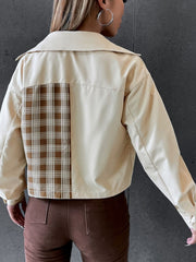 Beige jacket with plaid panel and faux leather details, buttoned collar, long sleeves.