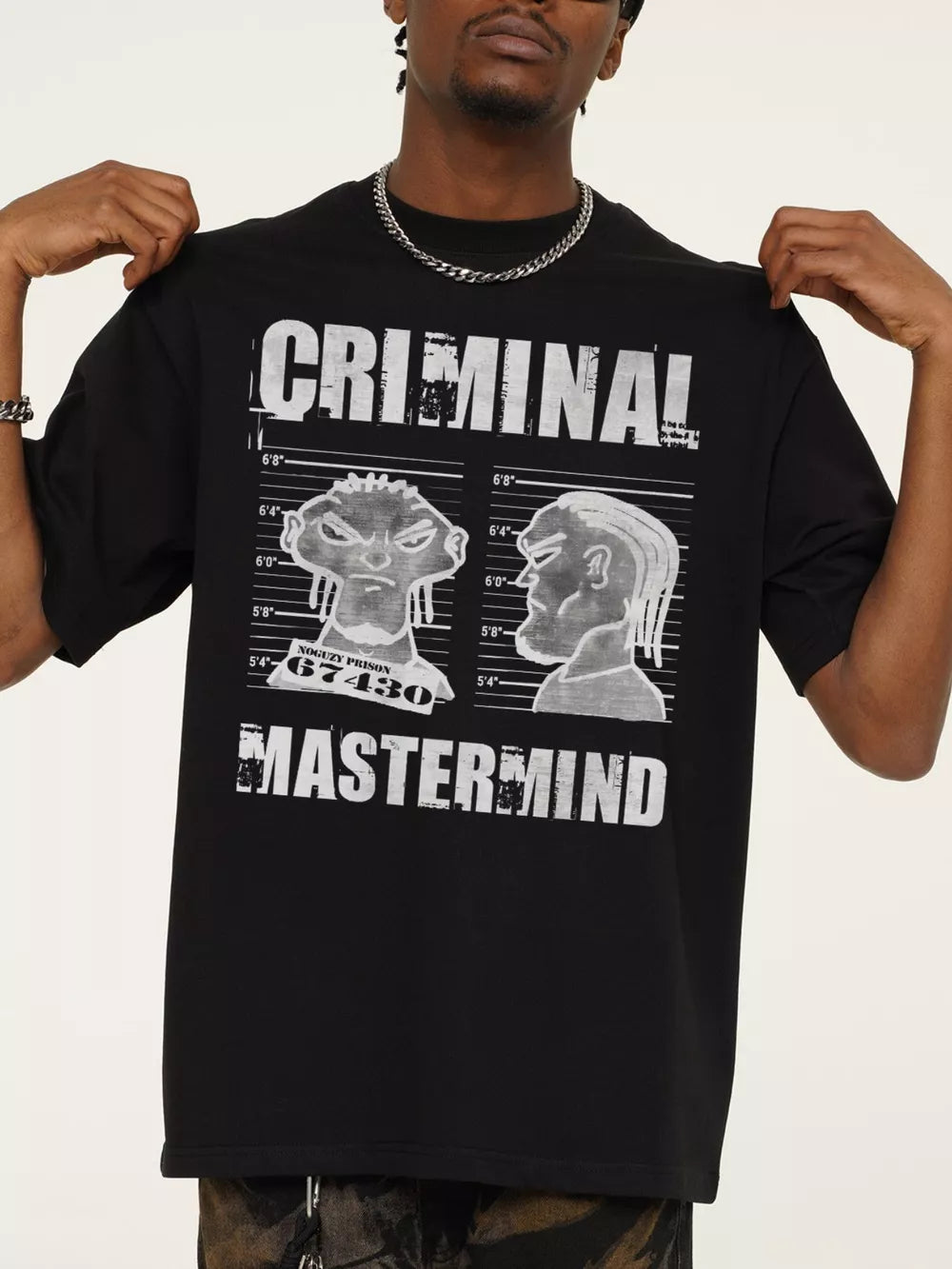 Black cotton oversized tee with a bold white "CRIMINAL MASTERMIND" graphic print and mugshot illustrations.