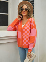 Checkerboard block knit cardigan in orange and pink with button front and V-neck.