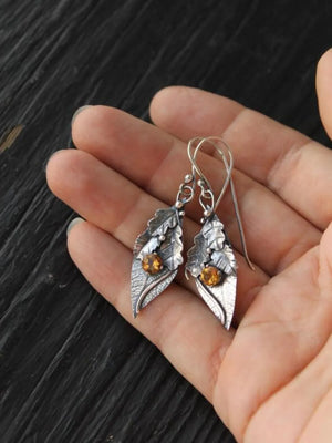 Textured leaf drop earrings with citrine stones in yellow, crafted from alloy.
