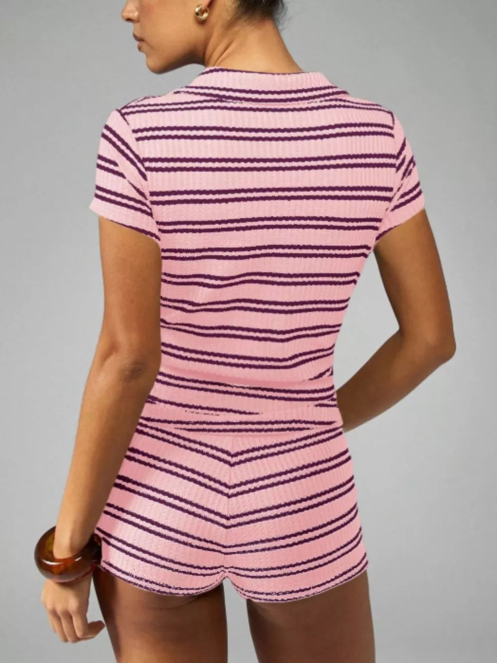 Pink striped knit two-piece set with short sleeves and shorts.