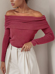Burgundy off the shoulder knit sweater with draped neckline and long sleeves.