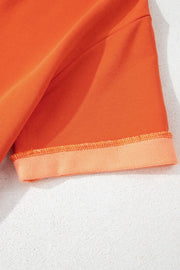 Orange colorblock V-neck romper with cuffed hem detail
