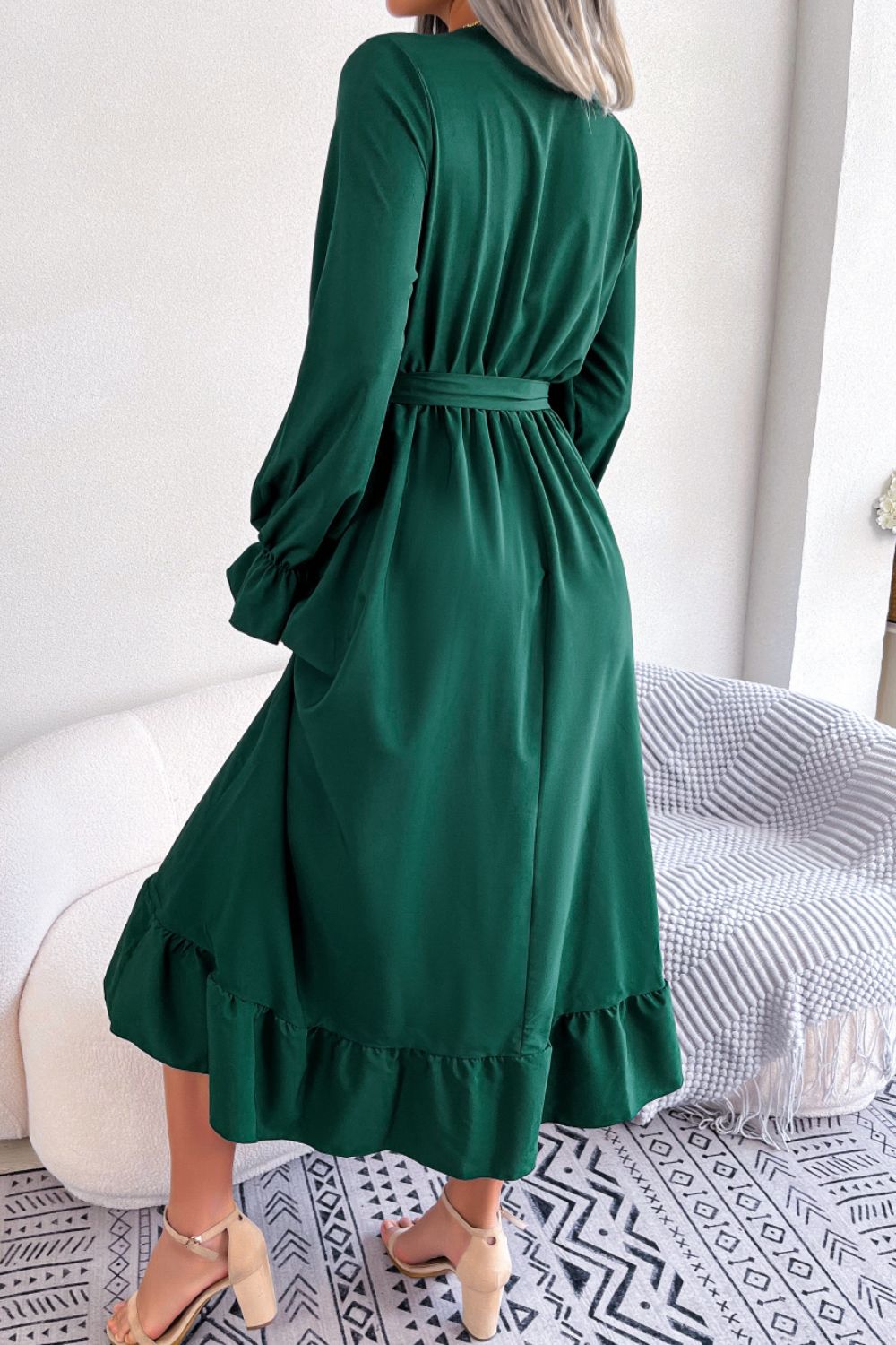 Forest green midi dress with tie waist, ruffled hem, and balloon sleeves.