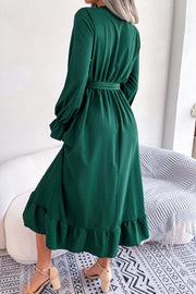 Forest green midi dress with tie waist, ruffled hem, and balloon sleeves.