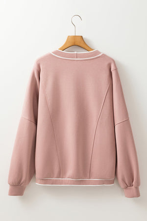 Dusty pink cocoon cardigan with white varsity trim and seam details.