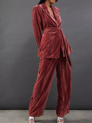 Velvet belted blazer and wide leg trousers ensemble in burgundy, with a textured finish.