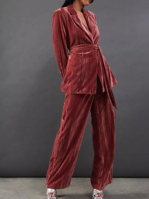 Velvet belted blazer and wide leg trousers ensemble in burgundy, with a textured finish.