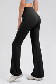 Black flared leggings with a high waist and performance fit, shown from the back.