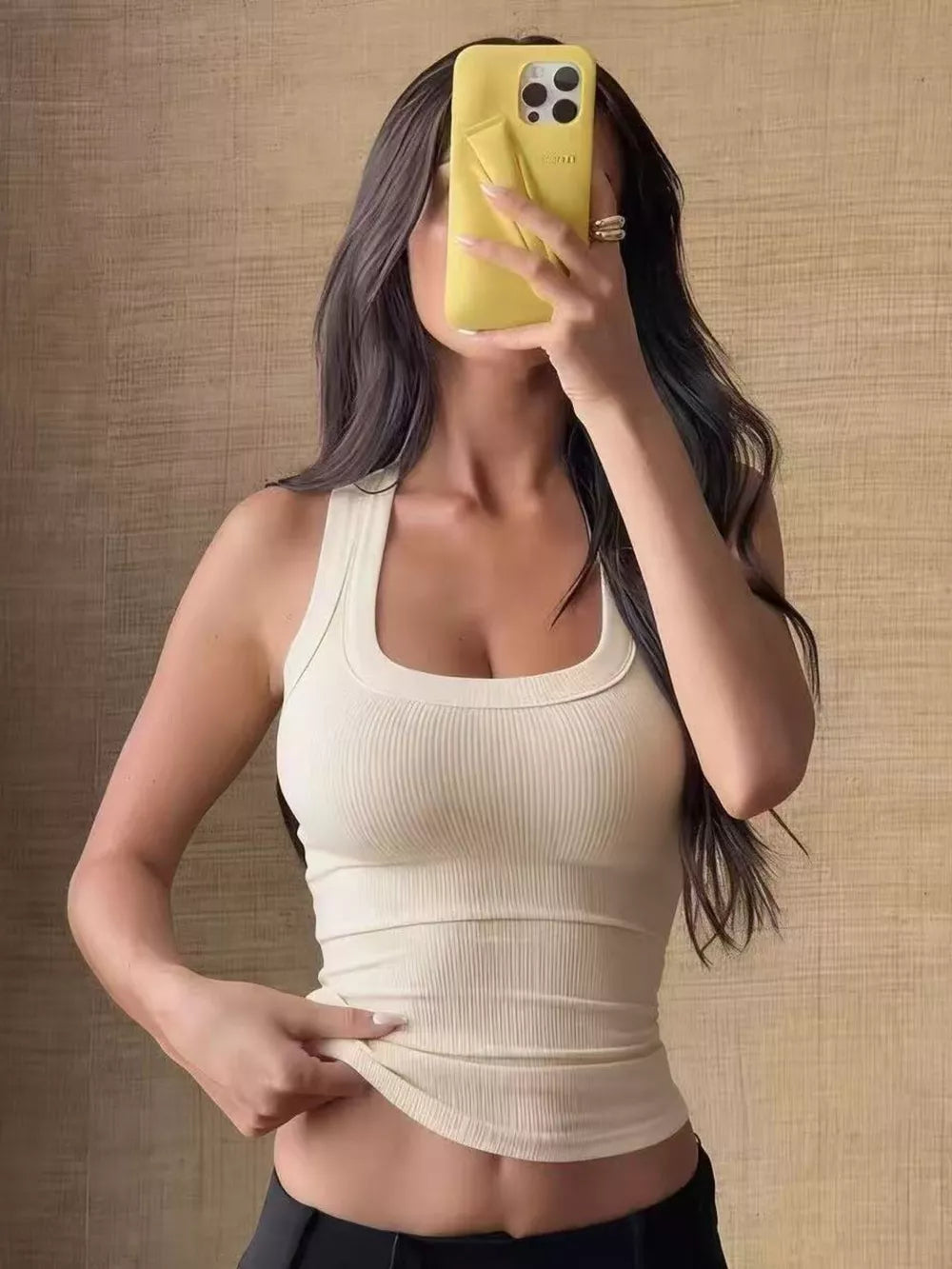 Apricot ribbed knit tank top with scoop neck and cropped length.