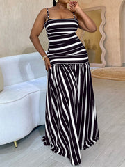 Plus size black and white striped maxi dress with spaghetti straps and a tiered skirt.