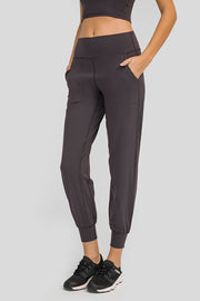 Dark Gray jogger fit performance trousers with pockets and cuffed ankles.