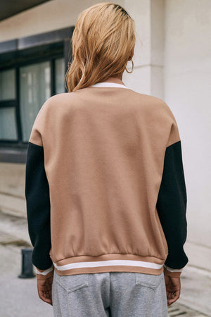 Camel bomber jacket with black sleeves and striped ribbed hem