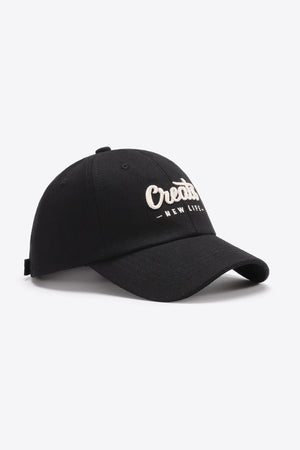 Black baseball cap with white embroidered "Create New Life" text detail