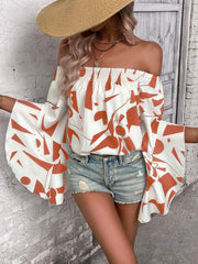 White off-shoulder blouse with orange geometric print and flared bell sleeves.