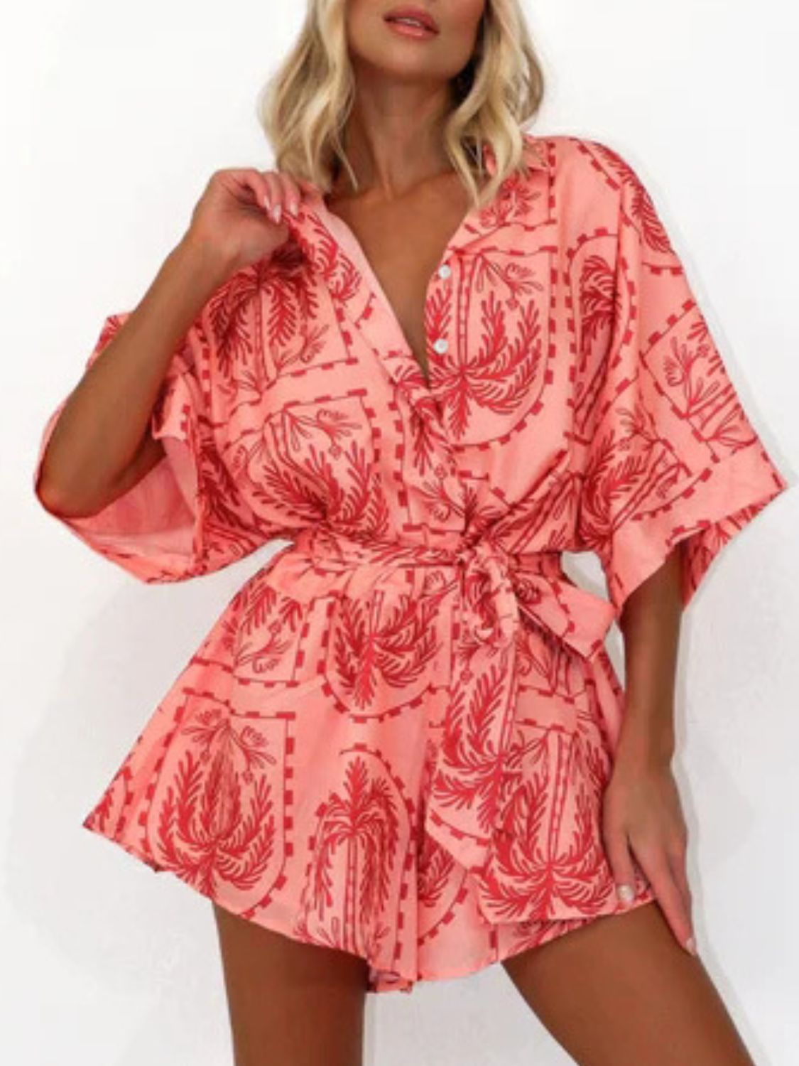 Coral wrap romper with celestial palm print and tie waist