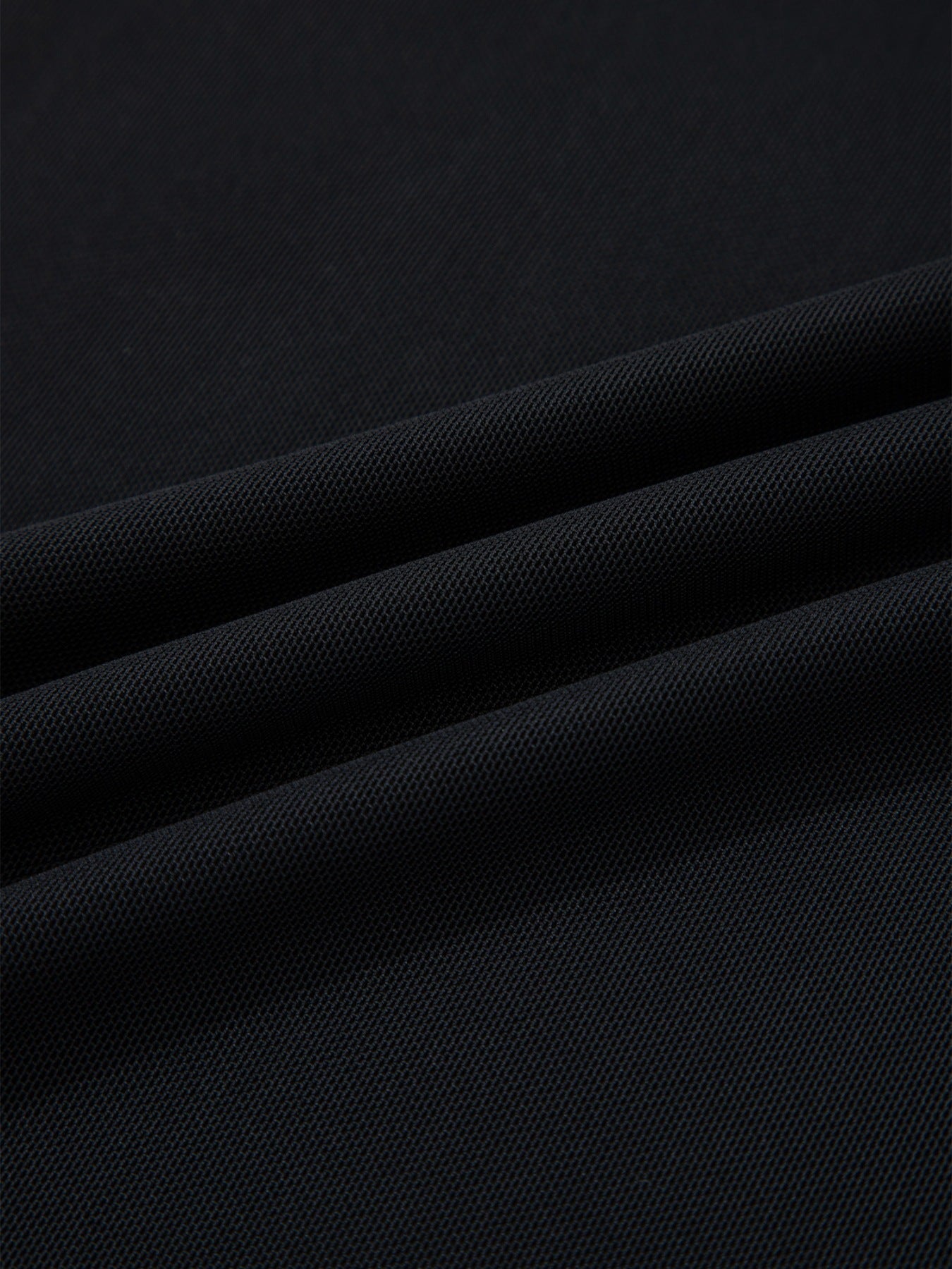 Black sheer mesh fabric detail of a cap sleeve t-shirt
