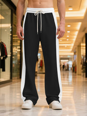 Men's black sweatpants with white side stripes and drawstring waist.