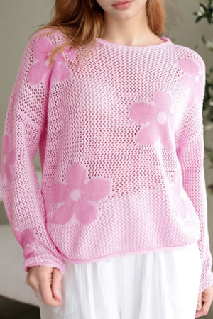 Openwork floral intarsia sweater in blush pink acrylic with a crew neck and long sleeves.