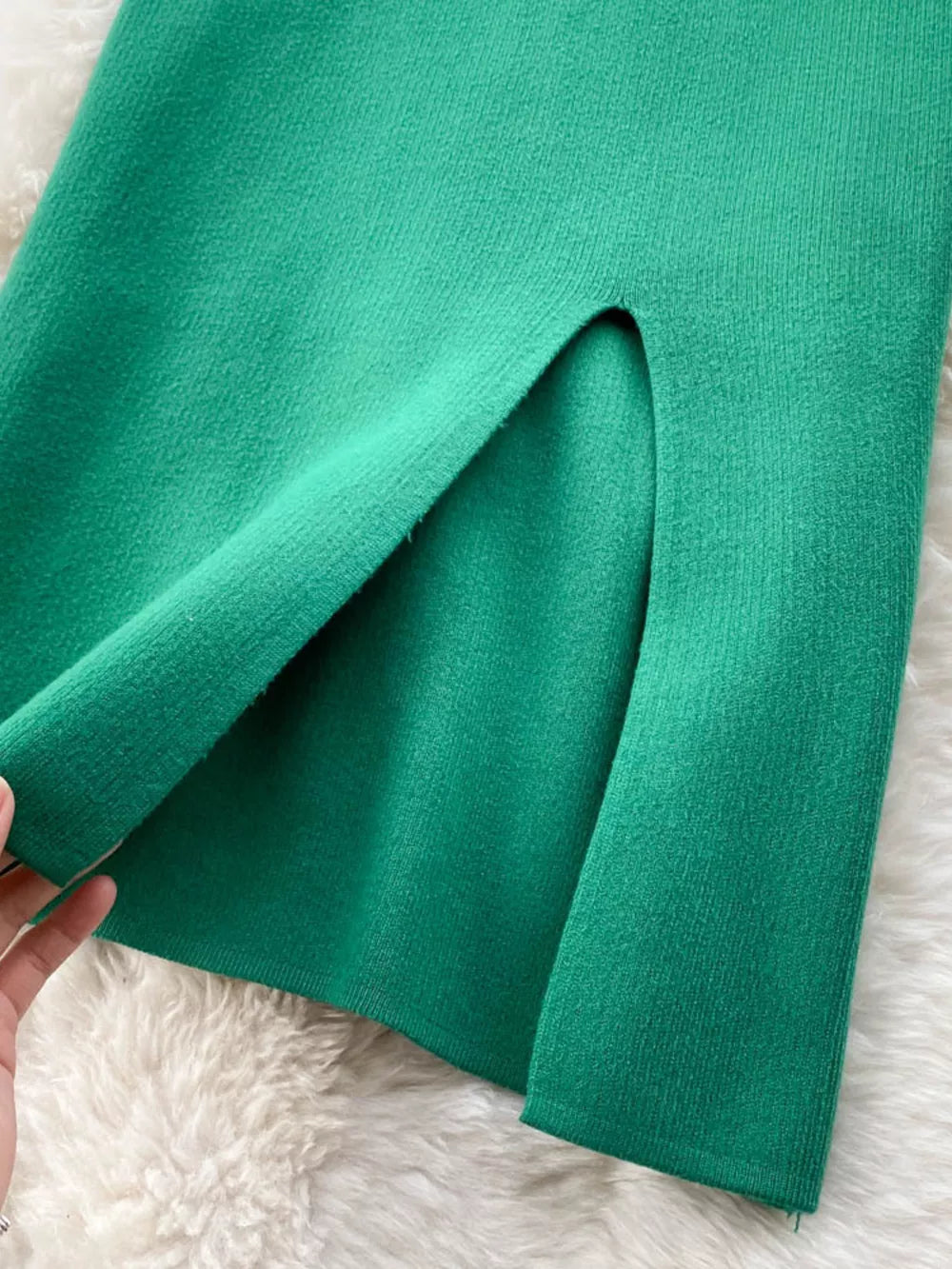 Green knit midi skirt with a high split detail.