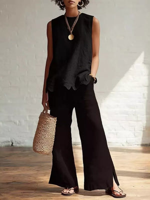 Black sleeveless tank top with scalloped hem and round neckline.