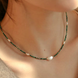 Elegant freshwater pearl and malachite beaded necklace with gold accents.