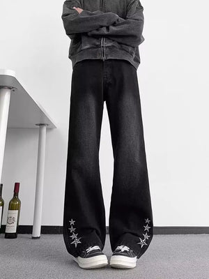 Men's black wide-leg jeans with star embellishments on the cuffs, made of 100% cotton.