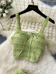 Green ruched crop top with tie detail and frill trim.