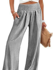 Smocked high-waist wide-leg pants in black and white gingham with pockets.