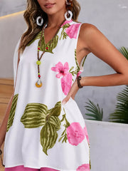 Floral V-neck sleeveless top with pink flowers and green leaves on white.