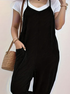Black spaghetti strap jumpsuit with V-neck and pockets, worn over a white tee.