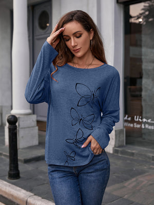 Dusty blue long sleeve slouchy tee with a black butterfly graphic print.