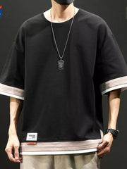 Black cotton blend t-shirt with contrast stitching on sleeves and hem, loose fit.