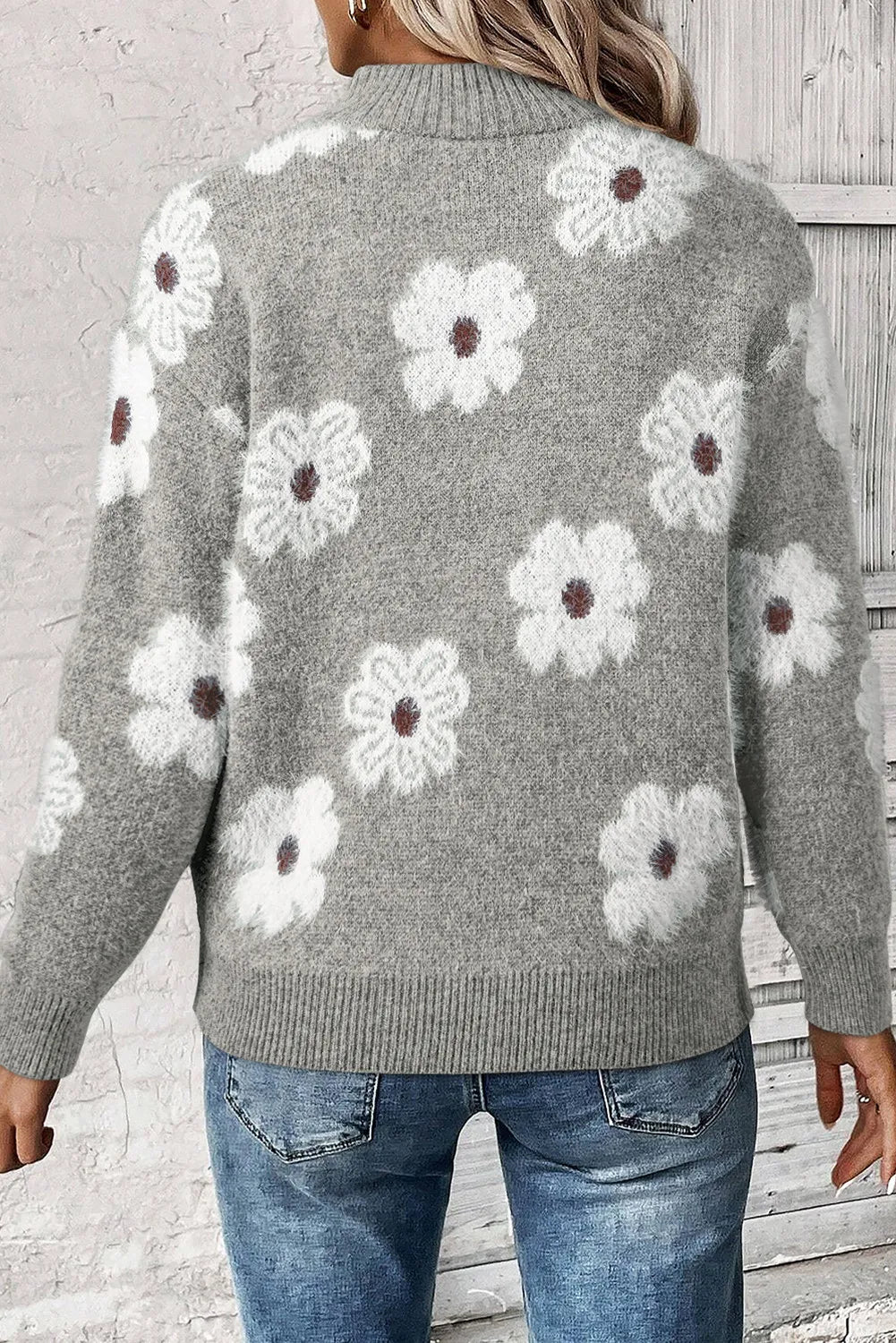 Gray acrylic sweater with white floral intarsia pattern and mock neck.