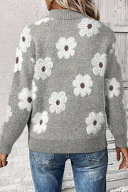 Gray acrylic sweater with white floral intarsia pattern and mock neck.