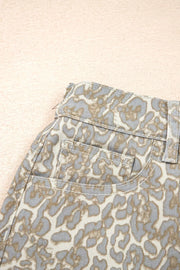 Denim shorts with a grey and tan leopard print, featuring front pockets and contrast stitching.