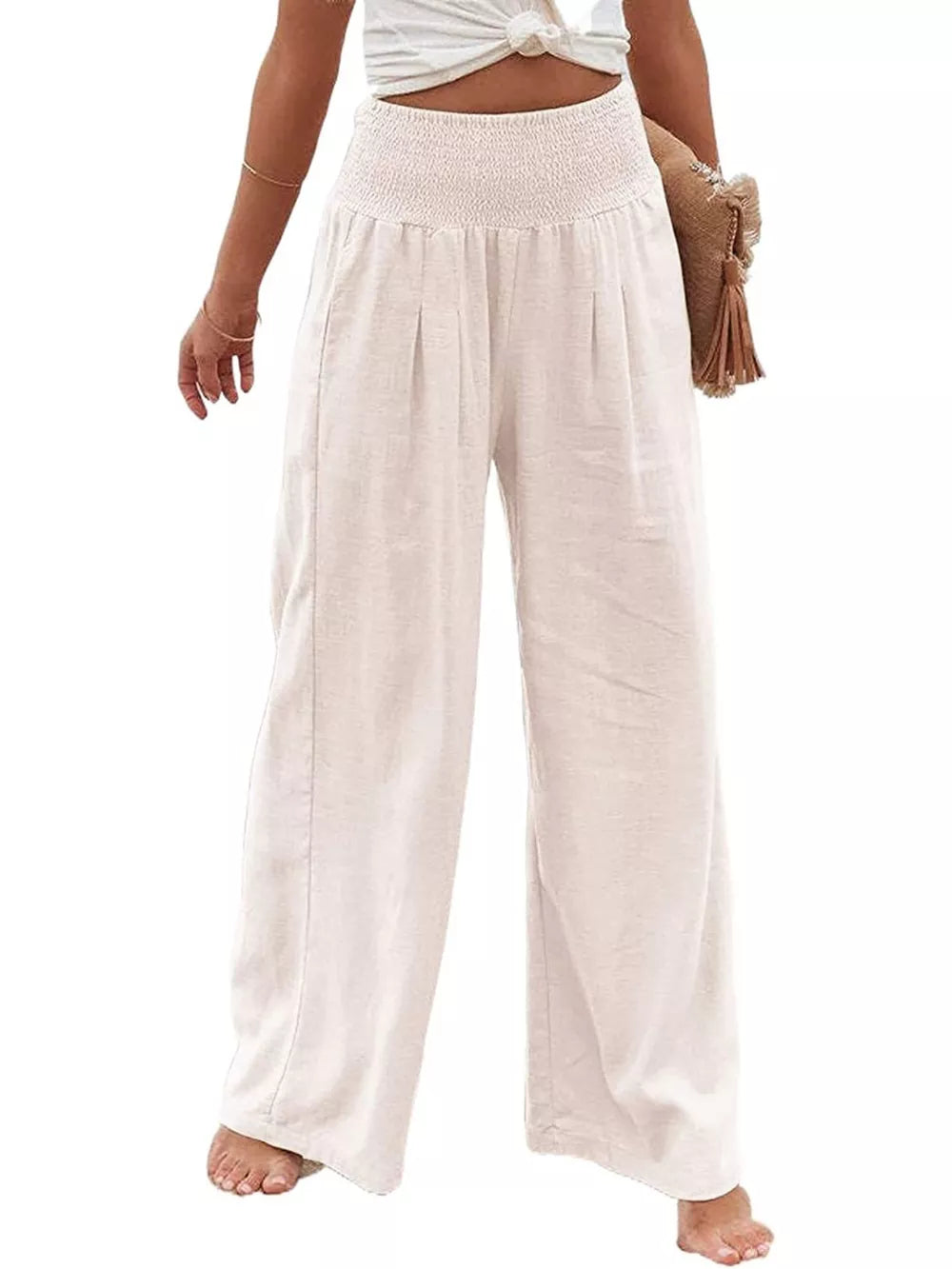 White smocked waist wide-leg maternity pants with a relaxed fit.