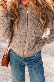 Mocha teddy bomber jacket with zip pockets and ribbed cuffs.