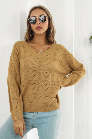 Camel V-neck knit pullover sweater with allover heart stitch pattern and ribbed cuffs and hem.
