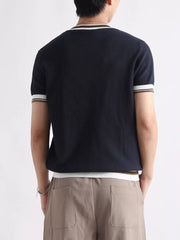 Textured ribbed crew neck t-shirt in navy with striped trim on collar and sleeves.