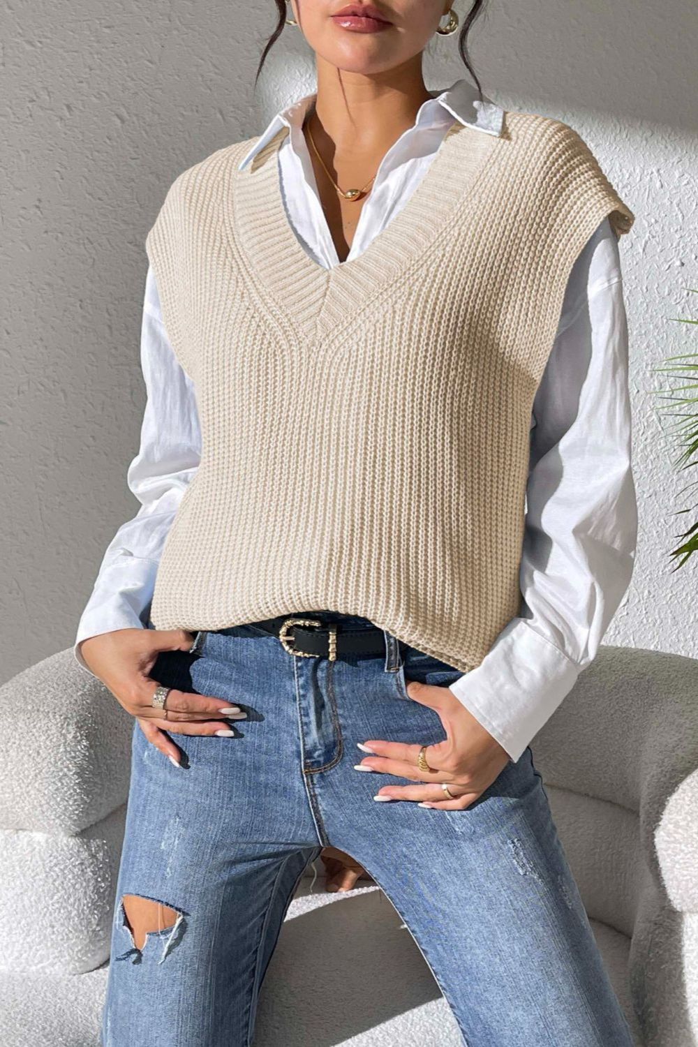 Beige textured knit V-neck sleeveless vest over a white collared shirt.
