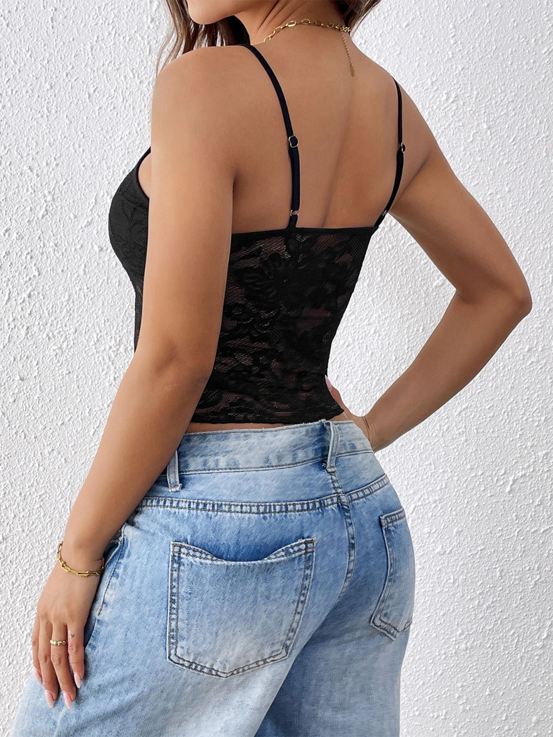 Black lace bustier cami with sheer panel and adjustable spaghetti straps.