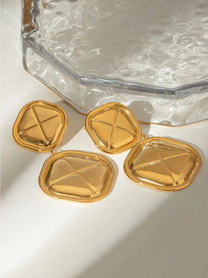 Sculpted geo drop earrings in gold-plated metal with a geometric pattern.