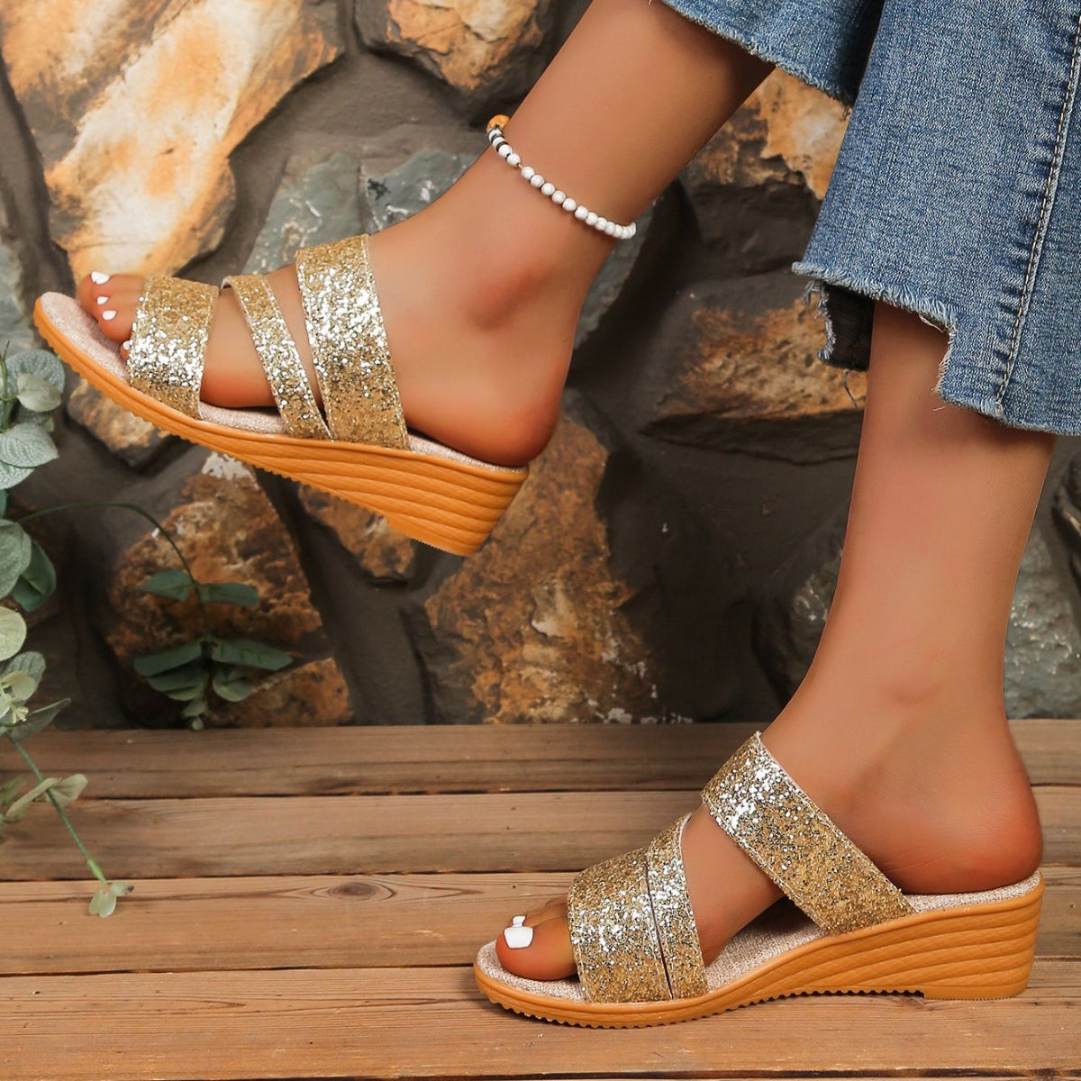 Gold sequined wedge sandals with double straps and a comfortable cork sole.
