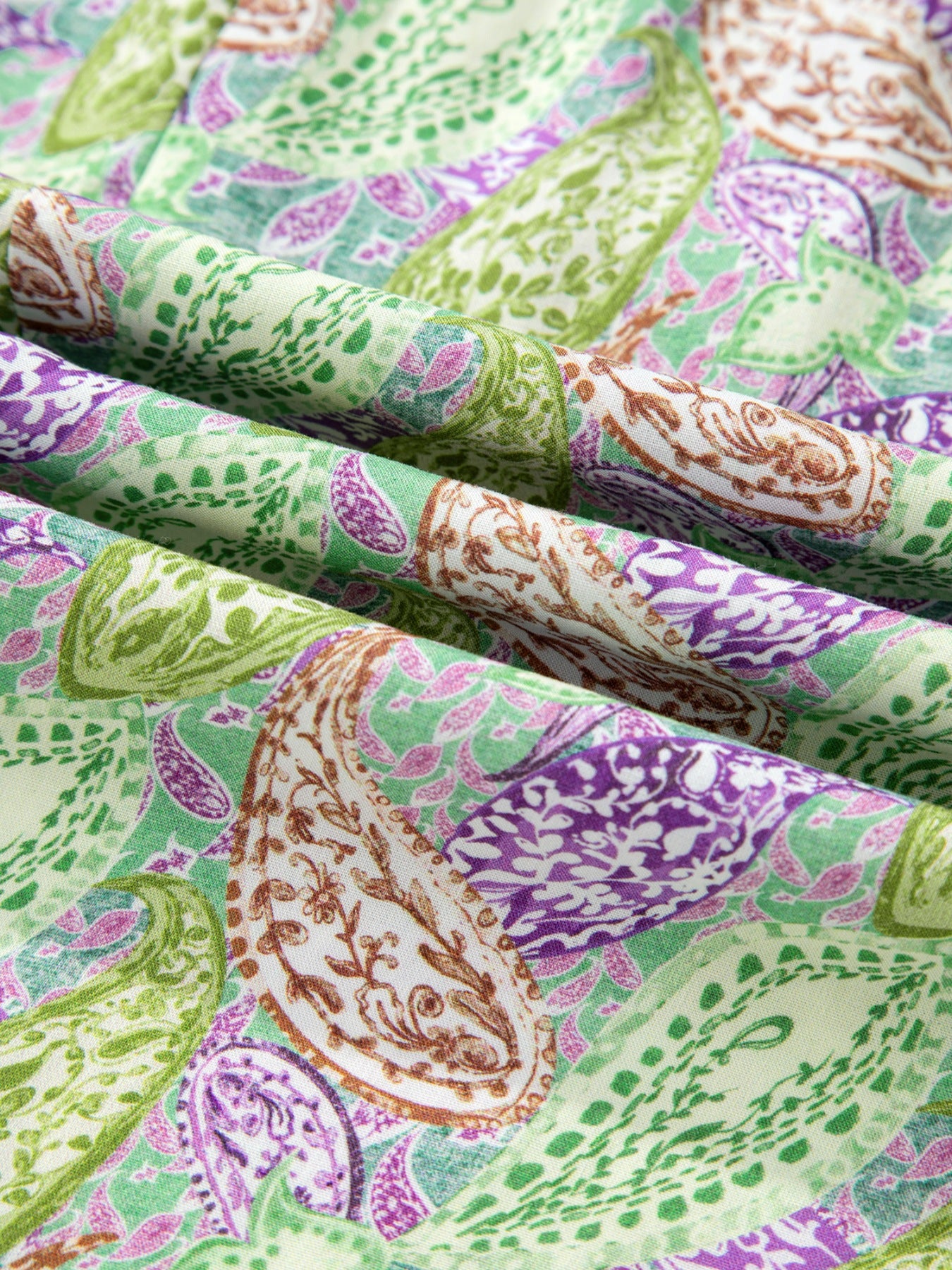 Paisley print blouse in cream with green and purple accents, featuring puff sleeves.