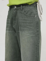 Faded olive wide leg denim jeans with a relaxed fit and visible pocket details.