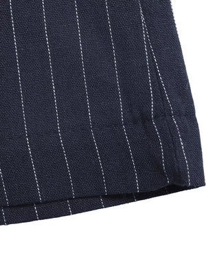 Navy pinstripe cotton maternity jumpsuit detail showing hem and stitching.