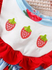 Baby one-piece with embroidered strawberries, red ruffles, and blue floral print.
